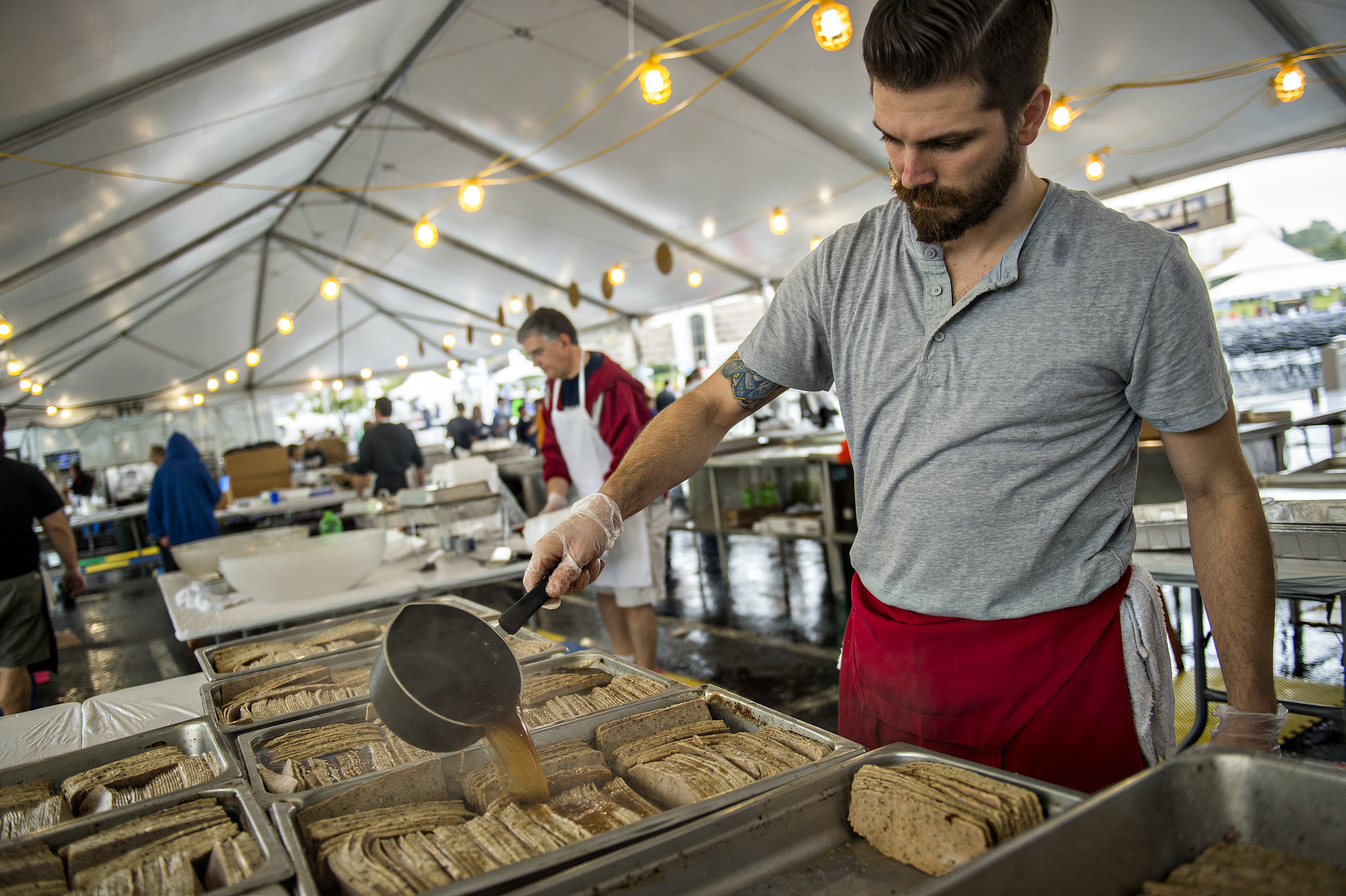 Peter Zakas Jr. marinates gyro meat during the Atlanta Greek Festival at the Greek Orthodox Cathedral of Annunciation on Saturday, September 26, 2015.