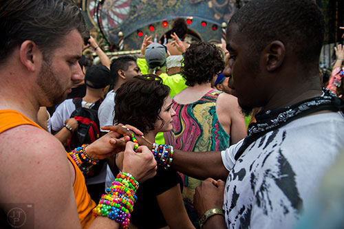 Sidney Harper (right) trades bracelets with a new found friend during TomorrowWorld in Chattahoochee Hills on Saturday, September 26, 2015. 