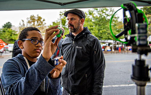 Jared Helton (left) tests an infrared gimble for lighting designed by Mark McJunkin during the Atlanta Maker Faire in Decatur on Saturday, October 3, 2015.