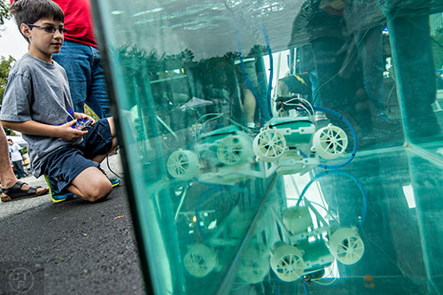 Antonio Santamaria (left) controls an underwater submarine during the Atlanta Maker Faire in Decatur on Saturday, October 3, 2015. 