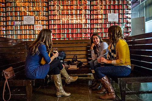 Aimee Corbin (left), Brit Parden and Mandy Putnam talk as they taste beers during the Second Self Beer Company's one year anniversary celebration in Atlanta on Saturday, October 3, 2015. 