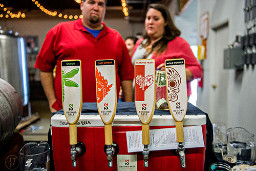 Austin Little (left) and Leslie Klein decide what beer to try during the Second Self Beer Company's one year anniversary celebration in Atlanta on Saturday, October 3, 2015. 