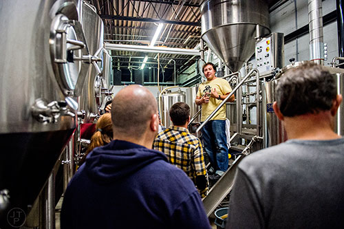 Jason Santamaria (center) leads a brewery tour during the Second Self Beer Company's one year anniversary celebration in Atlanta on Saturday, October 3, 2015. 