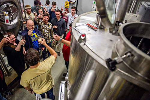 Ricki Sullivan (left), Mark Shields, Chris Price and Daniel Marsh raise their glasses with Jason Santamaria (bottom) as he leads a brewery tour during the Second Self Beer Company's one year anniversary celebration in Atlanta on Saturday, October 3, 2015. 