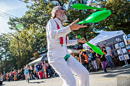 Charles Shapiro juggles as he rides his unicycle up the street during the Little Five Points Halloween Parade in Atlanta on Saturday, October 17, 2015. 
