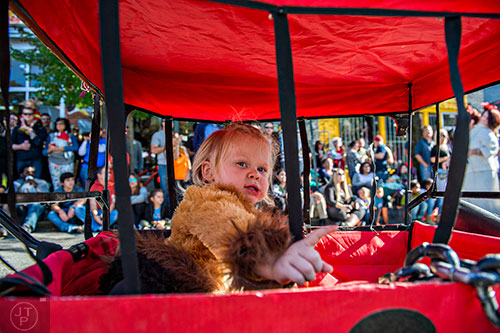 Tatum Bishop rides in her wagon during the Little Five Points Halloween Parade in Atlanta on Saturday, October 17, 2015.
