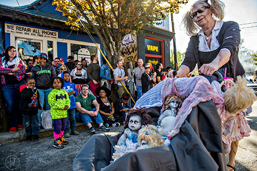 Chris Schott (right) pushes her dolls in a stroller during the Little Five Points Halloween Parade in Atlanta on Saturday, October 17, 2015. 