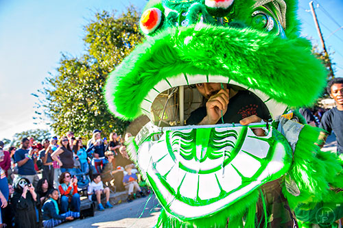 Andrew Zucker works the head of a Chinese dragon during the Little Five Points Halloween Parade in Atlanta on Saturday, October 17, 2015.
