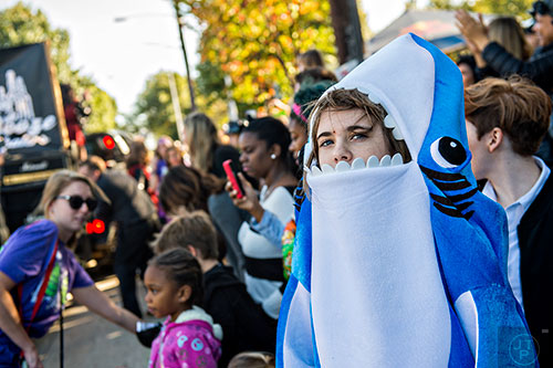 Sasha Payne (right) watches the Little Five Points Halloween Parade pass by in Atlanta on Saturday, October 17, 2015. 