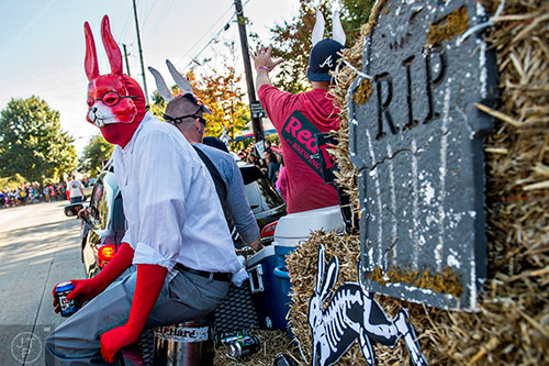 Teddy Vywics (left) rides on the back of a float during the Little Five Points Halloween Parade in Atlanta on Saturday, October 17, 2015. 