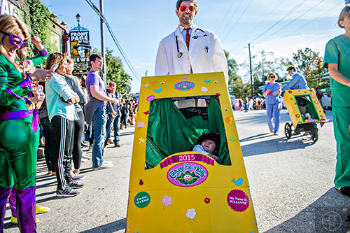 Jeff Gordan (center) pushes his daughter Julianne in a stroller during the Little Five Points Halloween Parade in Atlanta on Saturday, October 17, 2015. 