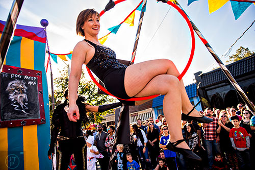 Carrie Cwiak (center) hangs from a trapeze during the Little Five Points Halloween Parade on Saturday, October 17, 2015. 