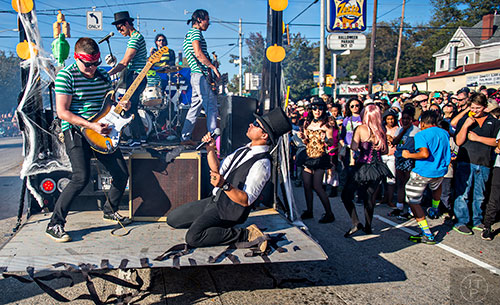 One of the numerous bands in the Little Five Points Halloween Parade performs on the back of a float as the crowd pushes onto the street on Saturday, October 17, 2015. 