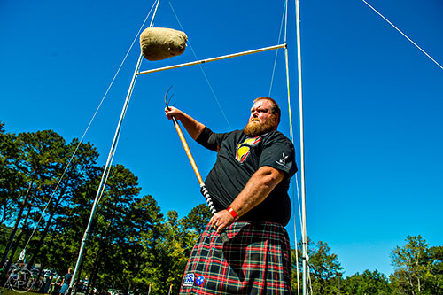 Josh Sharp competes in the sheaf toss during the 43rd annual Highland Games at Stone Mountain Park on Saturday, October 17, 2015. 