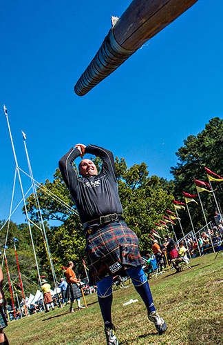 Eric Frasure warms up for the caber competition during the 43rd annual Highland Games at Stone Mountain Park on Saturday, October 17, 2015. 