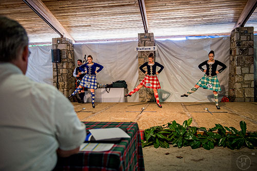 Isobel Lyttle (right), Caleigh Santamaria and Ava Smith are judged during the dancing competition during the 43rd annual Highland Games at Stone Mountain Park on Saturday, October 17, 2015. 