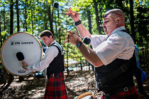 Neil Bills (right) and Cameron Drury warm up before competing during the 43rd annual Highland Games at Stone Mountain Park on Saturday, October 17, 2015. 