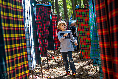 Danger Brown walks down the Forrest of Tartan during the 43rd annual Highland Games at Stone Mountain Park on Saturday, October 17, 2015. 