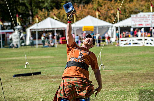 Davey Lewis launches a weight over his head during the 43rd annual Highland Games at Stone Mountain Park on Saturday, October 17, 2015. 