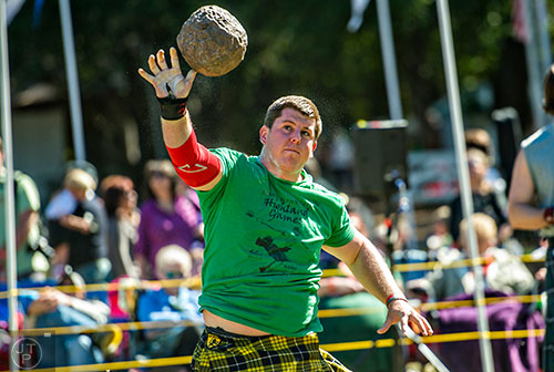 Justin Blatnik launches a stone into the air as he competes in the open stone event during the 43rd annual Highland Games at Stone Mountain Park on Saturday, October 17, 2015.