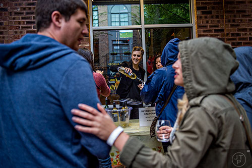 Kelly Cornett (center) pours wine as people wait in line during the Kirkwood Wine Stroll on Friday.