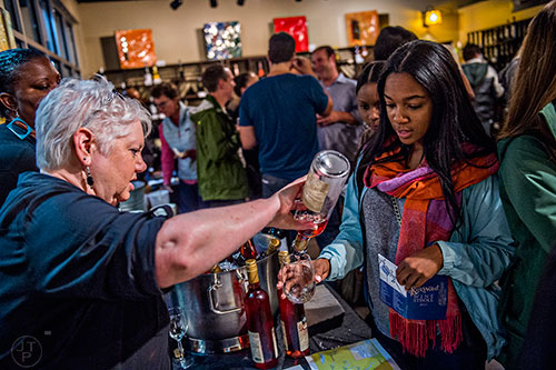 Debbie Jones (left) pours a glass of wine for Adonica Melson during the Kirkwood Wine Stroll on Friday. 
