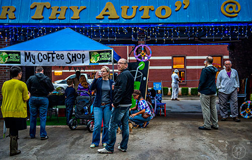 Susan Winkelmann (center) and Veit Munko stand near the decked out Honor Thy Auto during the Kirkwood Wine Stroll on Friday.