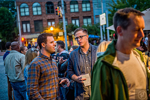 Jacob Fish (left) talks with Nathan Kimball as they wait in line for their next glass of wine during the Kirkwood Wine Stroll on Friday.