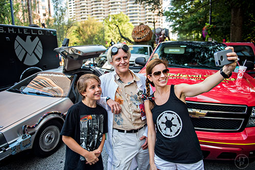 John Wagner (left) and his mother Amanda (right) take a selfie with Marty Sutton before the start of the annual DragonCon Parade in Atlanta on Saturday, September 5, 2015.