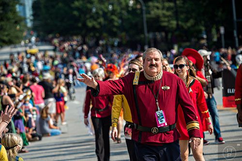 Dressed as Scotty from the Star Trek series and movies, Larry Robertson gives the Vulcan live long and prosper symbol as he marches down Peachtree St. in Atlanta during the annual DragonCon Parade on Saturday.