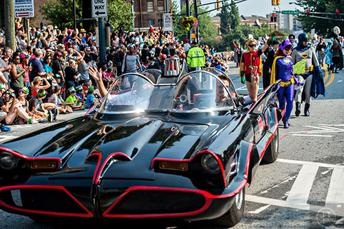 Dressed as Batgirl, Jennifer Rineskso follows the Batmobile down Peachtree St. in Atlanta during the annual DragonCon Parade on Saturday. 