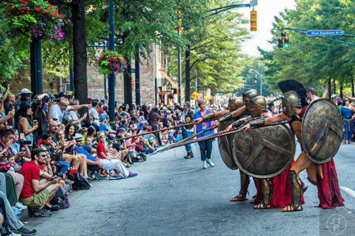Spartans from the movie 300 play with the crowd as they make their way down Peachtree St. in Atlanta during the annual DragonCon Parade on Saturday. 