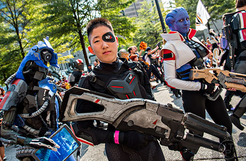 Part of the N7 Elite cosplay group, Jenna Albert (center) marches down Peachtree St. in Atlanta during the annual DragonCon Parade on Saturday, September 5, 2015.