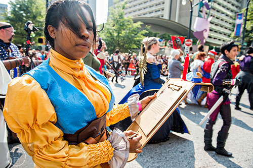 Dressed as Josephine from the Dragon Age series, Amber Carlisle marches down Peachtree St. in Atlanta during the annual DragonCon Parade on Saturday, September 5, 2015.