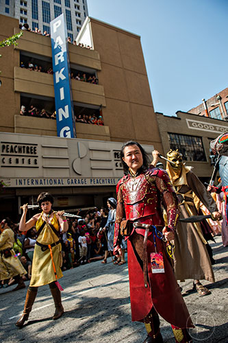 Michael Cook poses for photos from the crowd as he marches in the annual DragonCon Parade in Atlanta on Saturday, September 5, 2015.
