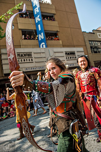 Abigail Singer plays up to the crowd during the annual DragonCon Parade in Atlanta on Saturday. 