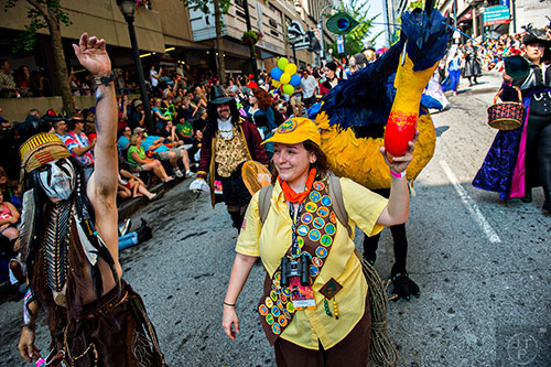Dressed as characters from the movie UP, Meaghan Brayton (center) leads her sister Brittany down the street during the annual DragonCon Parade in Atlanta on Saturday. 