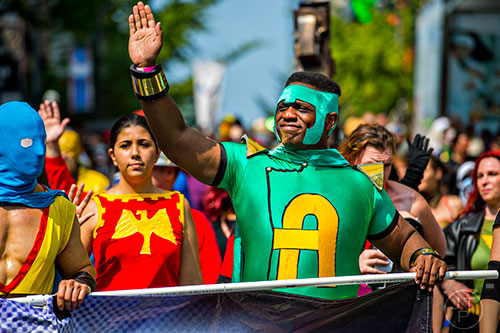Dressed as a super hero, Claude Hildreth waves to the crowd as he marches in the annual DragonCon Parade in Atlanta on Saturday, September 5, 2015.