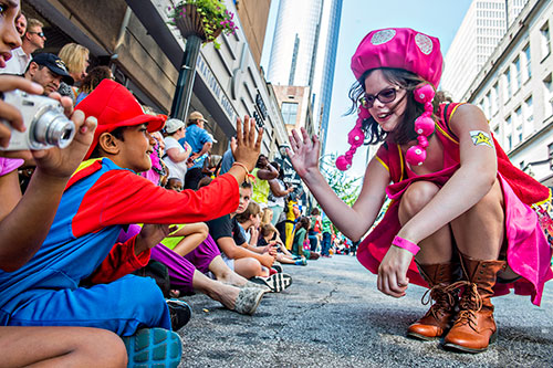 Dressed as Mario, Ishaam Kejriwal (left) gets a high five from Bethany Smith during the annual DragonCon Parade in Atlanta on Saturday, September 5, 2015.