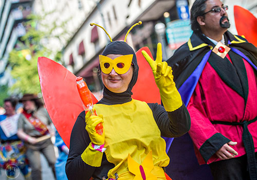 Dressed as Henchman 68, Allison Leibowitz gives the Venture Bros. sign during the annual DragonCon Parade in Atlanta on Saturday, September 5, 2015.