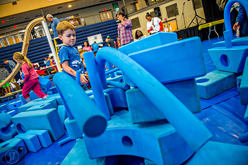 Harrison Taylor (center) plays in foam blocks during the Atlanta Maker Faire in Decatur on Saturday. 