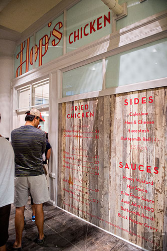 Check out the menu for Hop's Chicken while standing in line to order at Ponce City Market.