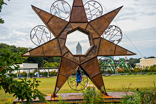Jacklyn Dashnaw climbs Charlie Smith's piece for Art on the Beltline "A 24/7 Timestar Lives".
