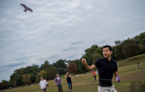 Bochen Li runs to try and keep his kite in the air during the Atlanta World Kite Festival at Piedmont Park on Saturday, October 24, 2015.