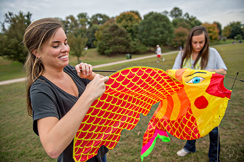 Rett Evans (left) and Katie Lansing put together a kite during the Atlanta World Kite Festival at Piedmont Park on Saturday, October 24, 2015. 