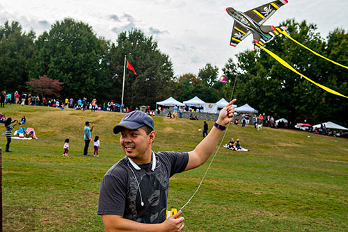 Donovan Faustino flies a kite during the Atlanta World Kite Festival at Piedmont Park on Saturday, October 24, 2015. 