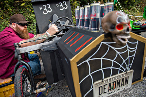 Chris Diganci puts the finishing touches on his team's vehicle before the start of the Red Bull Soap Box Derby in Atlanta on Saturday, October 24, 2015. 