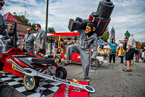 Dressed as a monkey, Jorge Palacio holds onto his giant drill before the start of the Red Bull Soap Box Derby in Atlanta on Saturday, October 24, 2015. 