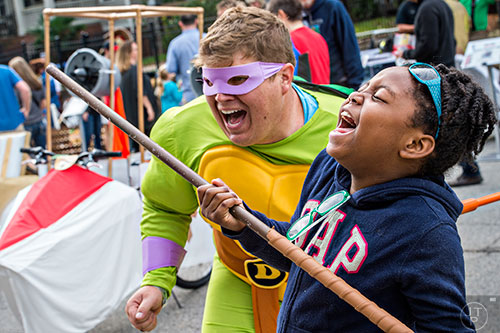 Tomiya Weaver (right) yells cowabunga with Mark Fuller before the start of the Red Bull Soap Box Derby in Atlanta on Saturday, October 24, 2015. 