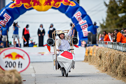 Dressed as the Pope, Koushi Ueda gives the peace sign to the crowd during the Red Bull Soap Box Derby in Atlanta on Saturday, October 24, 2015. 